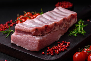 Raw pork ribs with meat with salt, spices and herbs