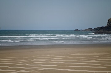 The waves at Canon Beach in Oregon have left ripples in the sandy beach