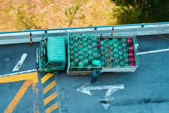 A view from above of a truck filled with gas bottles. Delivery of gas cylinders