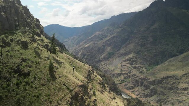 Aerial push in to canyon hillside in Hells Canyon Idaho above Snake River