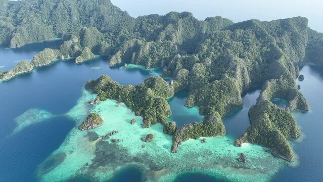 Dramatic limestone islands, eroded over millions of years, rise from Raja Ampat's seascape. This area of eastern Indonesia is known for its spectacular marine biodiversity.