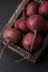Fresh raw beetroot in the form of tubers on a textured concrete background
