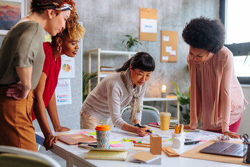 Female corporate team working on project together.