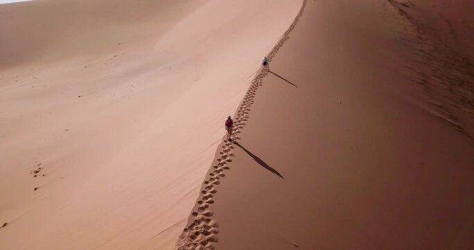 4K Aerial drone footage of Sossusvlei in Namibia. Aerial view of Deadvlei, located in the southern part of the Namib Desert. Hiking up to the top of Big Daddy dune. Cinematic High quality footage.