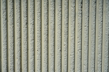 A striped concrete wall as a background.