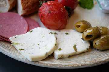 cheese tomato and olive on a plate 