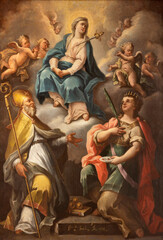 NAPLES, ITALY - APRIL 22, 2023: The painting of Virgin Mary with the St. Nicholas and Lucia in the church Chiesa della Pieta dei Turchini by Giuseppe Scala (1722).