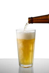  beer bottle filling a beer glass