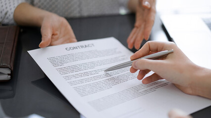 Businesswoman lawyer pointing into contract special points admitting something for colleague or client at meeting. Business people teamwork and partnership