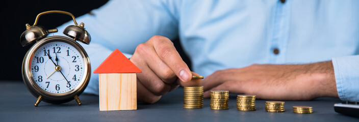 man hand coins with house model