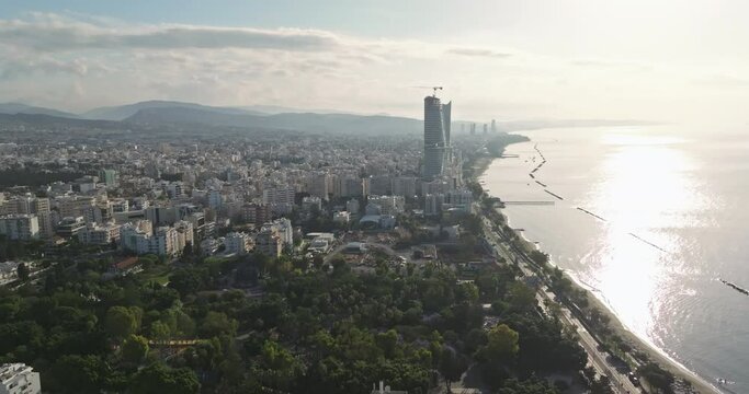 Aerial view of the city landscape of Limassol, Cyprus. The embankment of the resort town with high-rises and resort hotels on the coastline of the Mediterranean Sea. High quality 4k footage