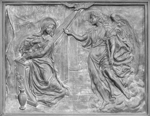 NAPLES, ITALY - APRIL 22, 2023:  The bronze relief of Annunciation on the gate of church Basilica...