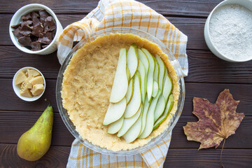 Pear pie preparation, top view. Tasty autumn dessert. 