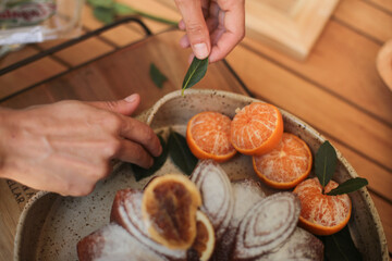 Bolo em forma de flor, delicadamente açucarado, adornado com tangerinas, em um evento social chique