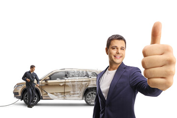 Satisfied customer gesturing thumbs up at a carwash
