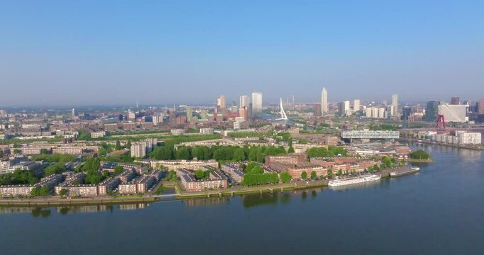 Drone video over the Meuse and Rotterdam city center in the morning at sunrise