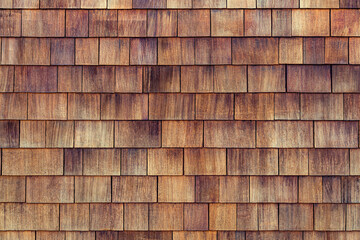Natural cedar shingle siding.Rough bumpy wood shingle cladding, row of wooden material of small shingle wall facade.Shingle red cedar wooden shake wood siding row roof panel made of larch conifer tree