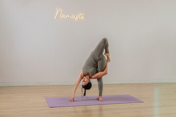 Young mexican woman doing headstand yoga poses