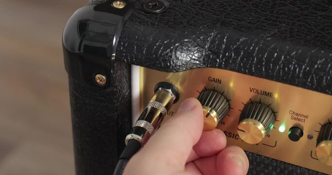Guitar amplifier closeup, cable connected