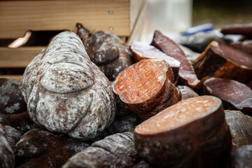 Serbian Sremski Kulen Kobasica sausage, handmade, piled and sliced in the coutryside of Serbia. Kulen is a traditional pork sausage, dry and cured, from Croatia and Serbia, from region of Srem.