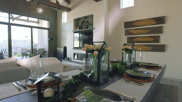 Rise Over Dining Room Table to Reveal Living Room. slow motion view inside a modern decorated home rising over the dining room table to reveal the living room