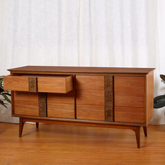 Vintage Mid-Century Modern Dresser. Walnut furniture. Interior scene with houseplants and a long white curtain.