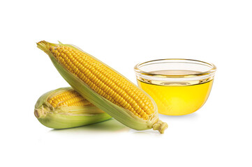 Cooking oil in glass bowl with corn cobs isolated on white background.