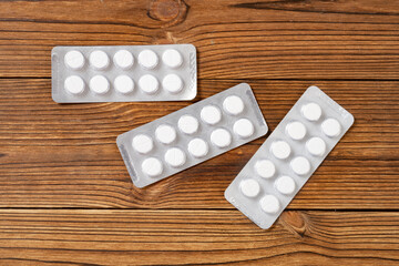 piles of pills on a wood background