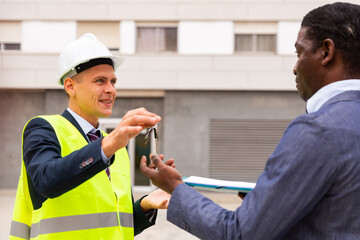 Happy architect transmits keys to the new african american businessman shopping center