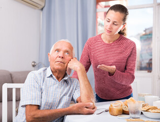 Adult daughter reassures offended father. High quality photo