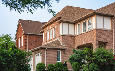 Perfect neighborhood Exterior Front House on a sunny day.Big custom made luxury houses with nicely landscaped front yard