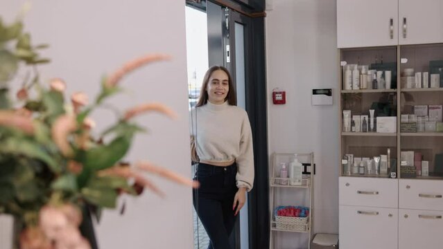 Cosmetic center, Treatment facility, Beauty clinic. Female patron steps into grounds cosmetology clinic.