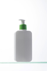 A mockup of a white dispenser with a cosmetic product for skin care of the face and body. Shower gel, facial cleanser.