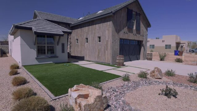 Southwest Barn Style Home Exterior Left Angle Move Towards. view moving toward left angle over rock front façade of a unique southwestern home exterior