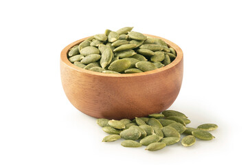 Pumpkin seeds in wooden bowl on white background.