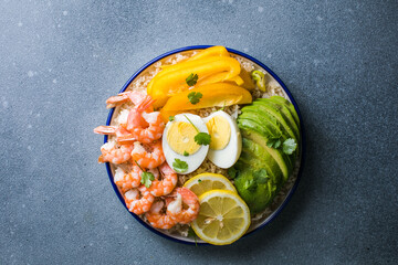 Buddha bowl with avocado, prawns, rice,  on light background. Healthy food, clean eating, Buddha bowl, top view,