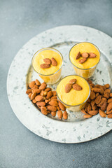 Authentic Indian cold drink made up of curd, milk malai called Lassi in saffron, kesar flavour, also called kesariya or keshariya or kesar lassi, served in  glasses