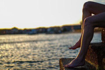 feet on stairs of a breakwater