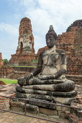 Fototapeta na wymiar Buddha statue in temple complex at Wat Mahathat in Ayutthaya.