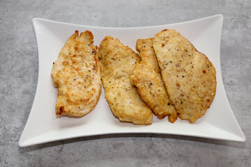 Seasoned chicken fillets dredged on flour and fried with olive oil and butter to make chicken piccata.