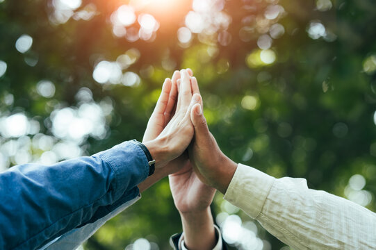 High five teamwork is a team together. unity concept Conservation of nature, the environment, groups of people of various nationalities business team success concept together