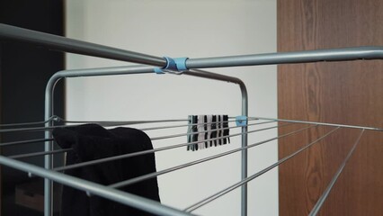 Hanging up black socks on a drying rack