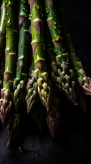 washed asparagus spears black background.