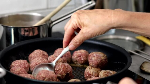 A woman prepares Swedish meatballs in a kitchen