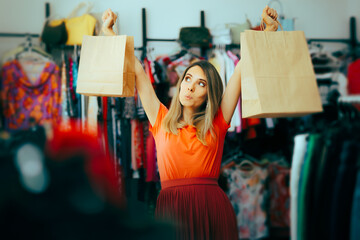 Happy Woman Holding Shopping Bags Feeling Excited. Compulsive shopper feeling endorphin and dopamine rush 
 - obrazy, fototapety, plakaty