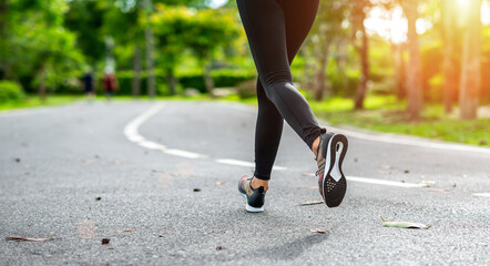 young asian woman runner athlete running at garden