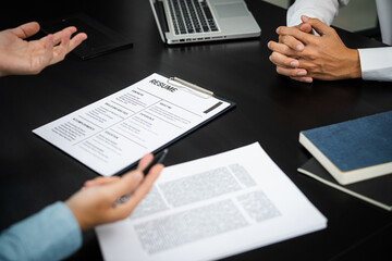 Examiner reading a resume during job interview at office Business and human resources concept.