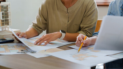 Architects interior designer hands working with Blue prints and documents for a home renovation for house design