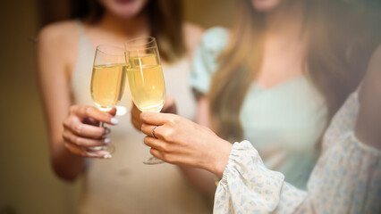 Group of friends celebrating with champagne  Close up on hands.