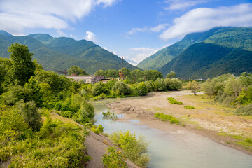 landscape with mountain river among spruce forest. beautiful sunny morning.white fluffy cloud on the sky.Picturesque mountain valley.wild Nature Reserve